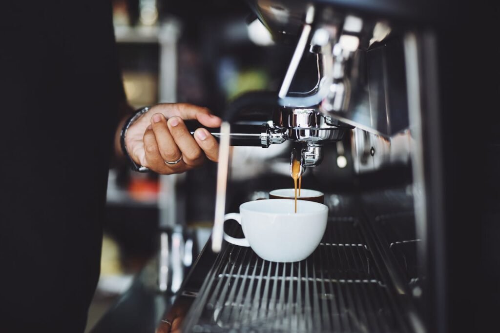 pexels-photo-302902 Close-up of a barista preparing espresso in a café using a machine
